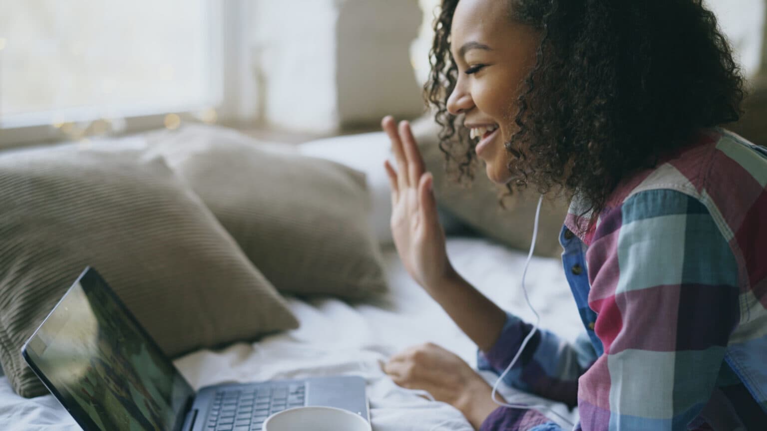 A woman talking warmly during a video therapy session